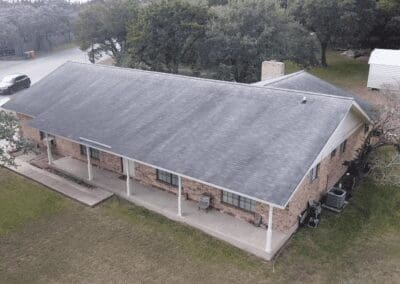 A large brick house with a roof that has been cleaned.