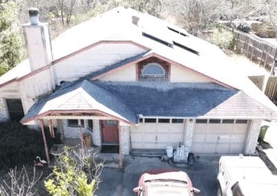 A car parked in front of a house with a garage.