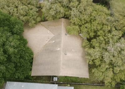 A parking lot with trees and bushes in the background.