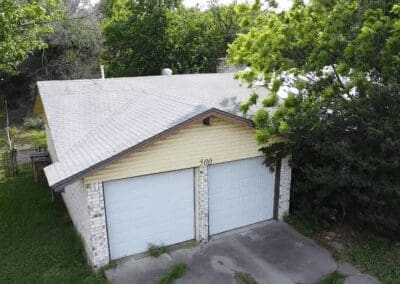 A garage with two doors and a roof.