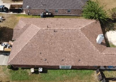 A brown roof with birds sitting on it.