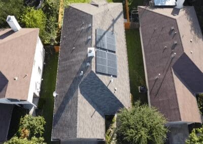 A view of a house with solar panels on the roof.