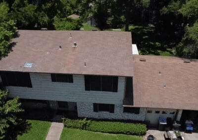 A house with brown roof and white walls.