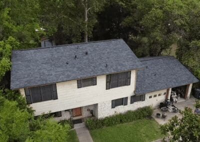 A house with a black roof and white trim.