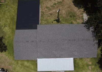 A bird 's eye view of a house with a solar panel on the roof.