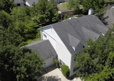 A white house with trees in the background