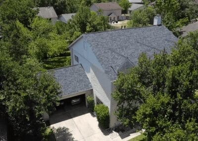 A house with trees and bushes in the background