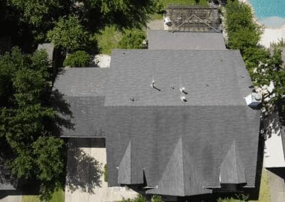 A bird 's eye view of a house with trees in the background.