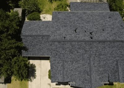 A bird 's eye view of a house with trees in the background.